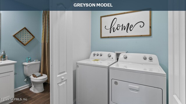 washroom featuring dark wood-type flooring and washer and dryer