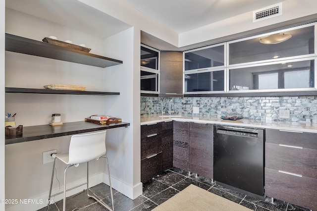 kitchen with dishwasher, dark brown cabinets, and tasteful backsplash