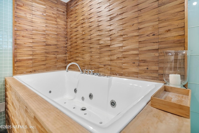 bathroom with tiled bath and tile walls