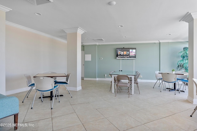 tiled dining area featuring ornate columns and crown molding