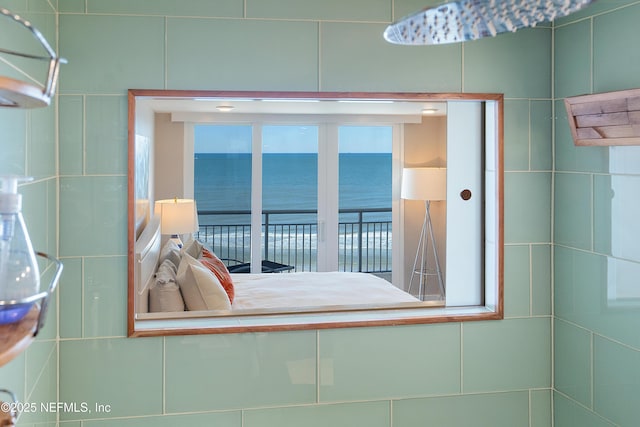 unfurnished bedroom featuring a water view