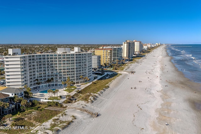 drone / aerial view with a beach view and a water view