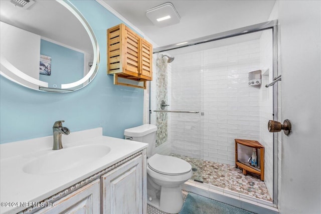 bathroom with vanity, toilet, and a tile shower