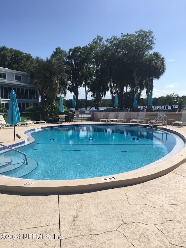 view of swimming pool with a patio area