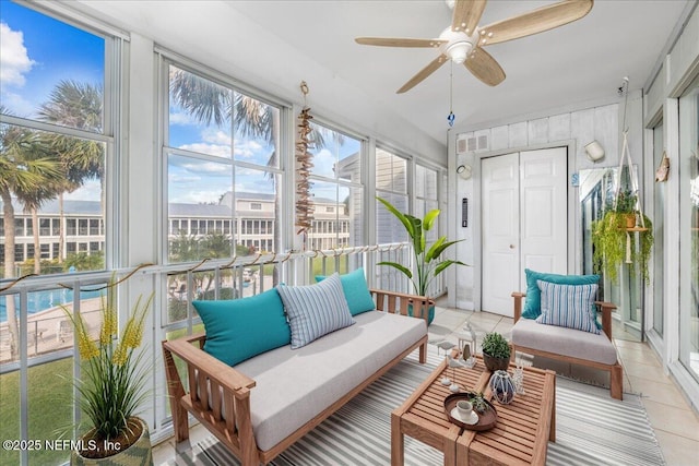 sunroom / solarium featuring ceiling fan