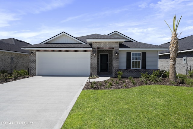 view of front of home with a garage and a front yard