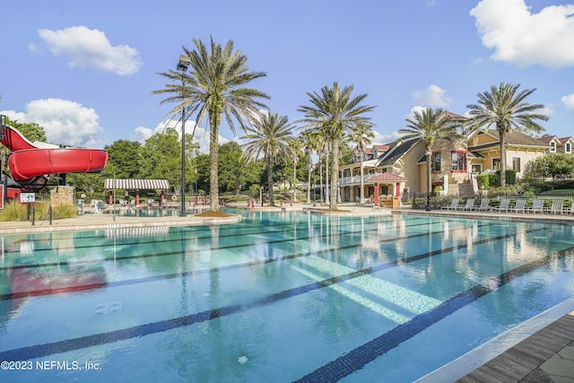 view of swimming pool with a water slide