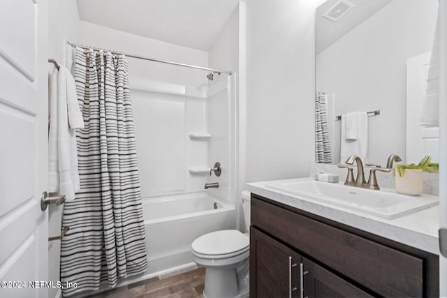 full bathroom with shower / bath combo with shower curtain, vanity, hardwood / wood-style floors, and toilet