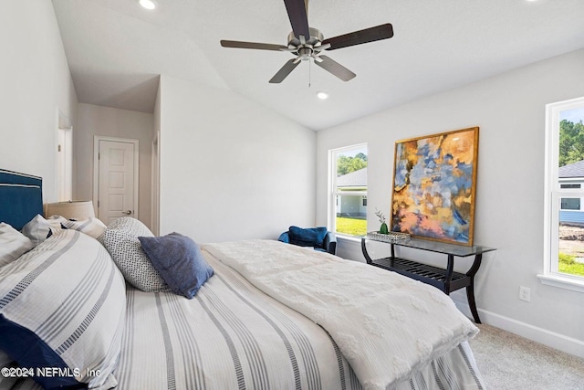 bedroom featuring carpet floors, vaulted ceiling, multiple windows, and ceiling fan