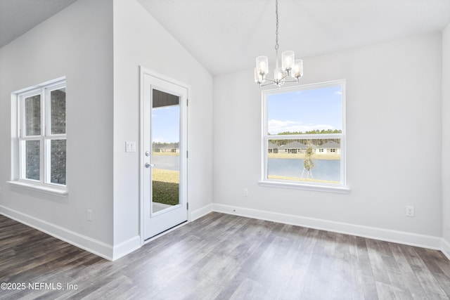 3239 Winding Creek Pl, Green Cove Springs, FL 32043 - unfurnished dining area featuring baseboards, lofted ceiling, wood finished floors, and an inviting chandelier