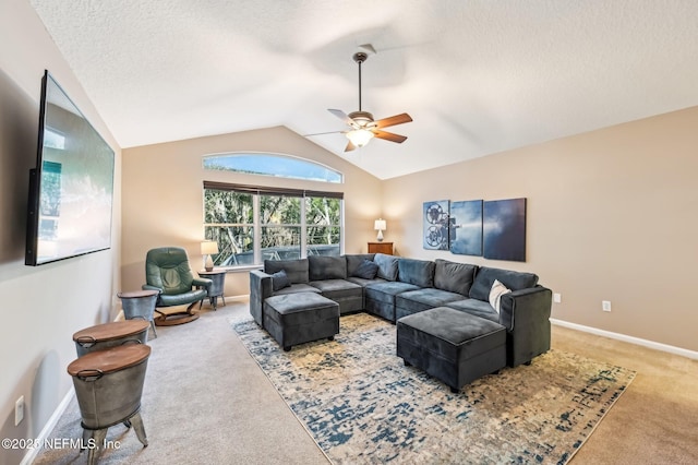 living room featuring a textured ceiling, ceiling fan, carpet floors, and lofted ceiling