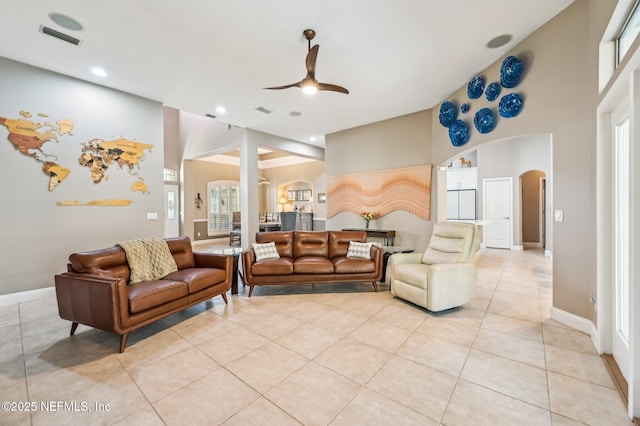 tiled living room featuring ceiling fan