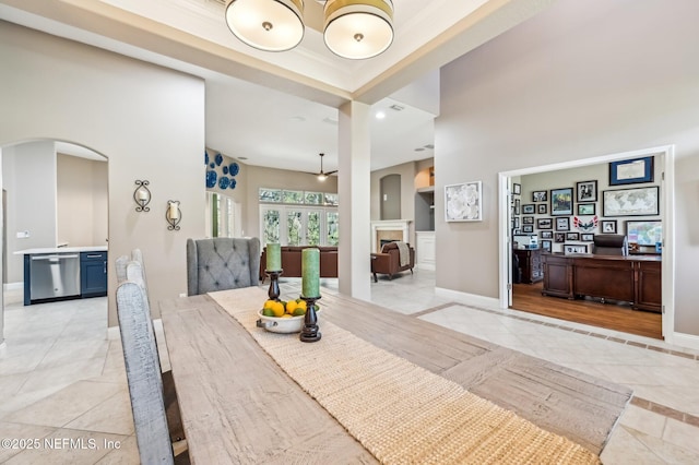 dining space featuring light tile patterned floors and ornamental molding