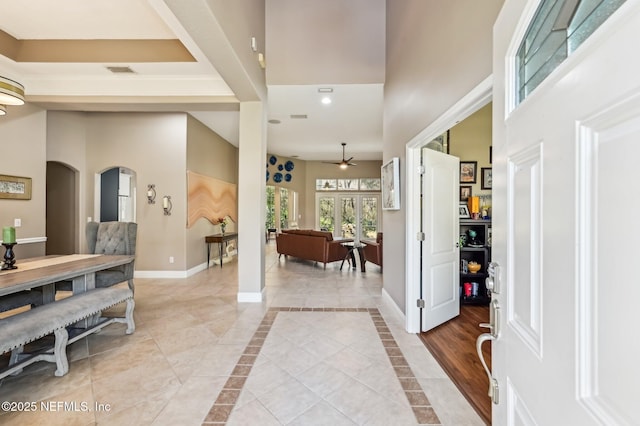 tiled entrance foyer featuring ceiling fan and french doors