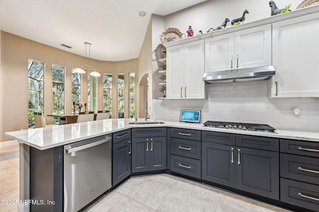 kitchen featuring white cabinets, stainless steel appliances, tasteful backsplash, and sink