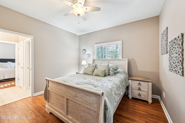 bedroom featuring dark hardwood / wood-style flooring and ceiling fan