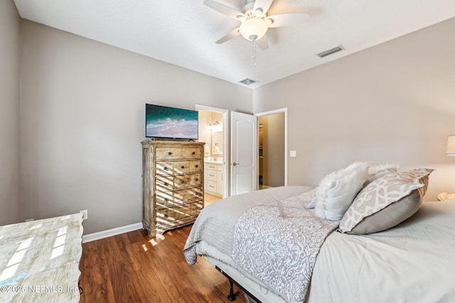 bedroom with ensuite bathroom, ceiling fan, and dark wood-type flooring