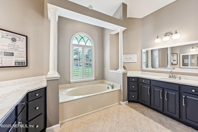 bathroom featuring a bathing tub, tile patterned flooring, and vanity