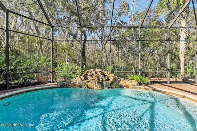 view of pool with a lanai and pool water feature