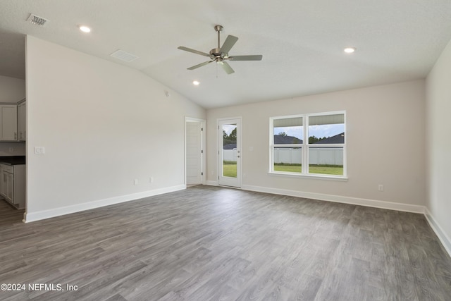 spare room with lofted ceiling, ceiling fan, and dark wood-type flooring