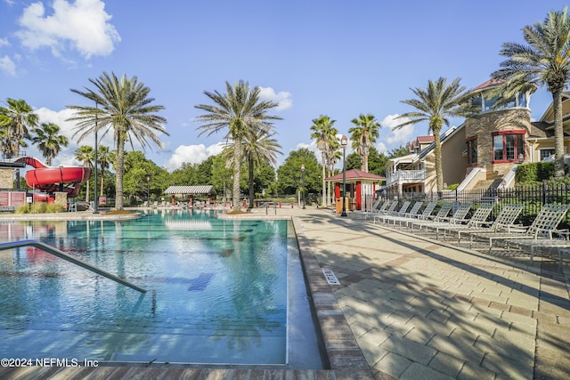 view of swimming pool with a water slide