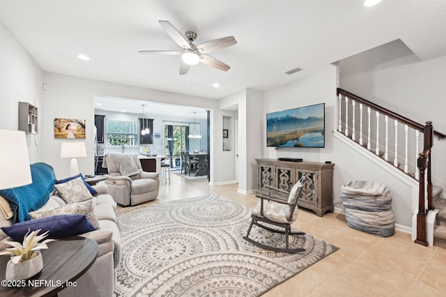 living room with light tile patterned floors and ceiling fan