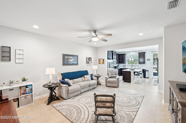 living room featuring ceiling fan and light tile patterned flooring