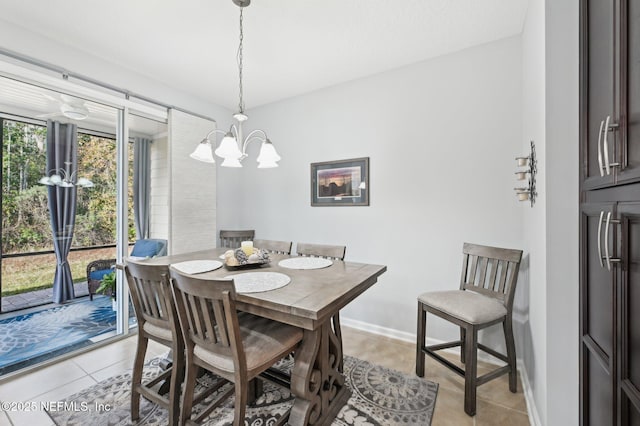 dining area featuring light tile patterned floors and a chandelier