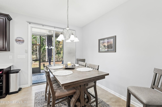 dining area featuring light tile patterned floors and an inviting chandelier