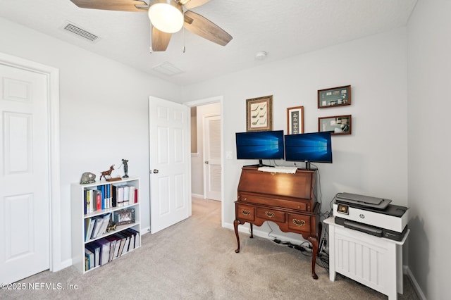 office space with ceiling fan and light colored carpet