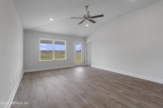 spare room featuring hardwood / wood-style floors, vaulted ceiling, and ceiling fan