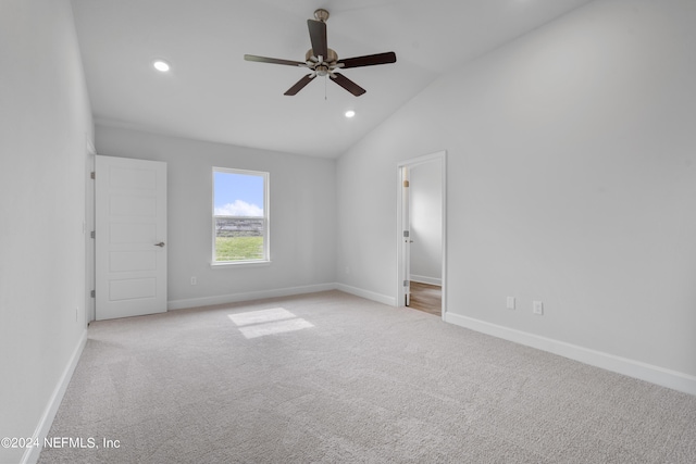 unfurnished room featuring light carpet, ceiling fan, and lofted ceiling