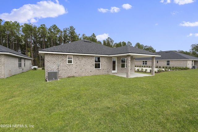 rear view of house featuring a lawn, a patio area, and central air condition unit