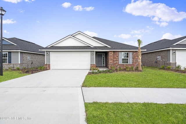 3245 Winding Creek Pl, Green Cove Springs, FL 32043 - ranch-style home with a front yard, concrete driveway, an attached garage, brick siding, and a shingled roof