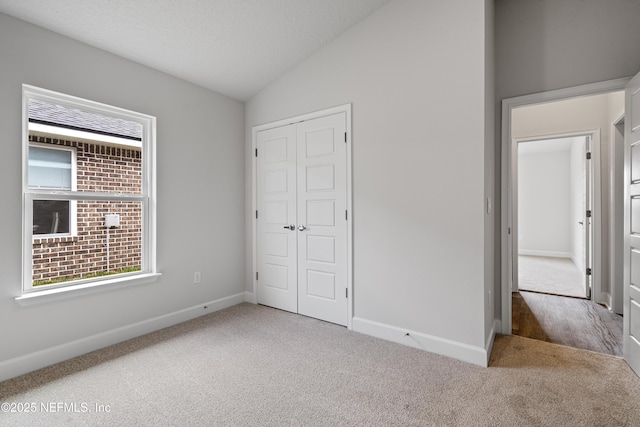 3245 Winding Creek Pl, Green Cove Springs, FL 32043 - unfurnished bedroom featuring a closet, carpet flooring, a textured ceiling, baseboards, and lofted ceiling