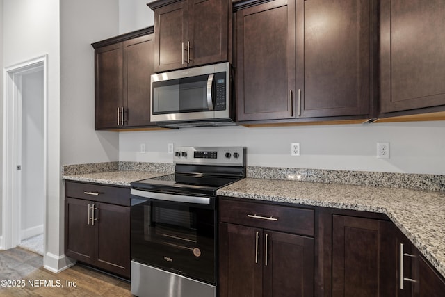 3245 Winding Creek Pl, Green Cove Springs, FL 32043 - kitchen featuring dark brown cabinetry, light stone countertops, dark wood-style floors, stainless steel appliances, and baseboards