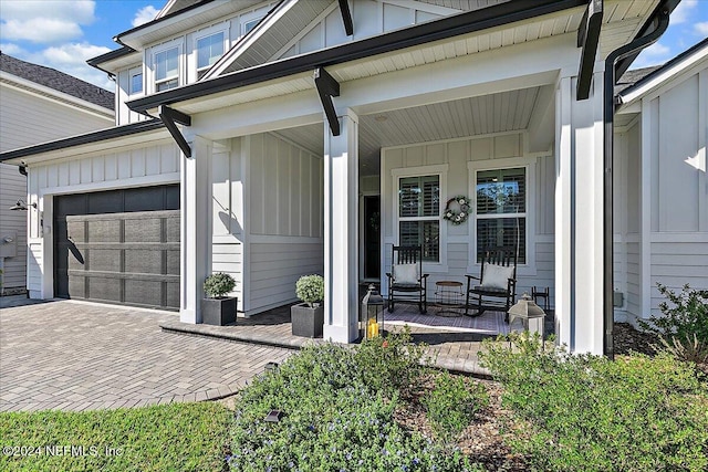 exterior space with covered porch and a garage