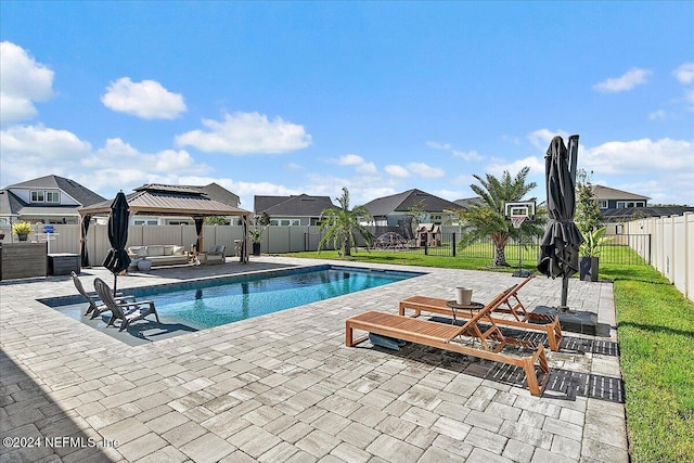 view of pool with a gazebo, an outdoor hangout area, a patio, and a yard