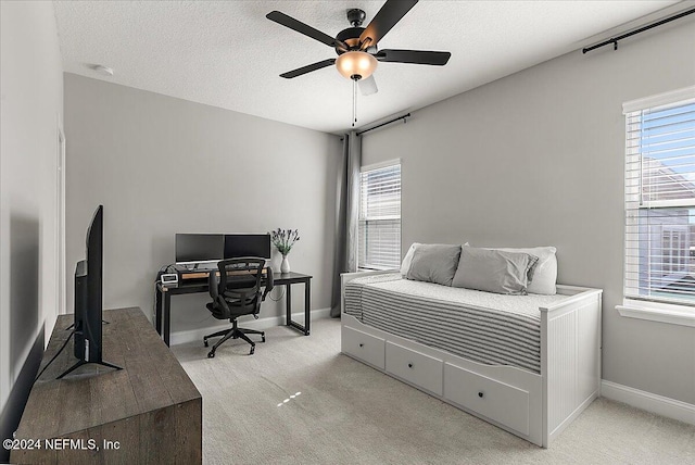 carpeted bedroom featuring a textured ceiling and ceiling fan