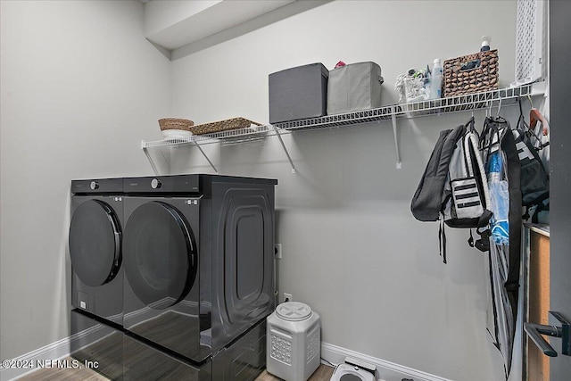 laundry area featuring independent washer and dryer and hardwood / wood-style floors