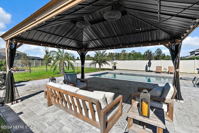 view of patio / terrace featuring a gazebo, an outdoor living space, and a fenced in pool