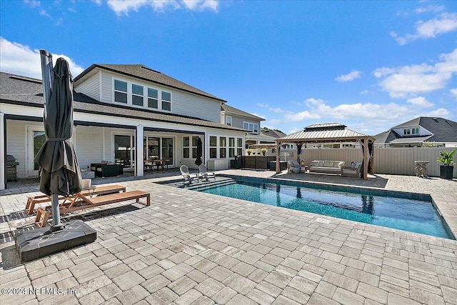 view of pool with a gazebo, a patio area, and an outdoor hangout area