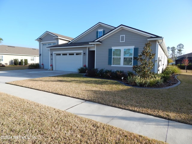 view of front of property featuring a garage and a front lawn