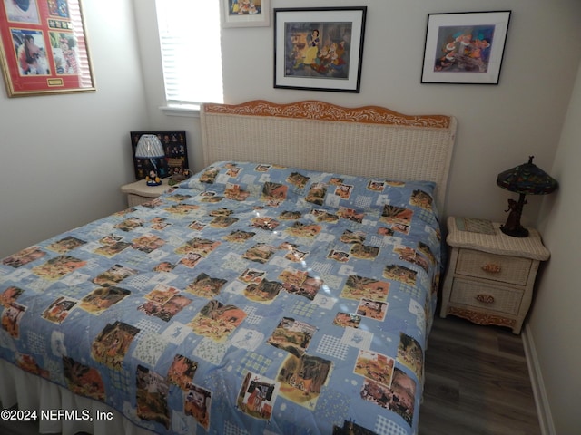 bedroom with dark wood-type flooring