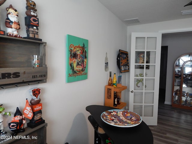 dining room with dark hardwood / wood-style flooring and french doors