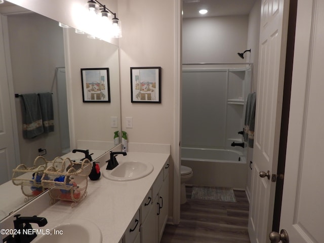 full bathroom with vanity, wood-type flooring, shower / bathtub combination, and toilet