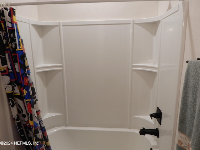 bathroom with shower / tub combo with curtain