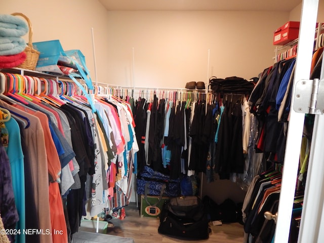 spacious closet featuring hardwood / wood-style floors