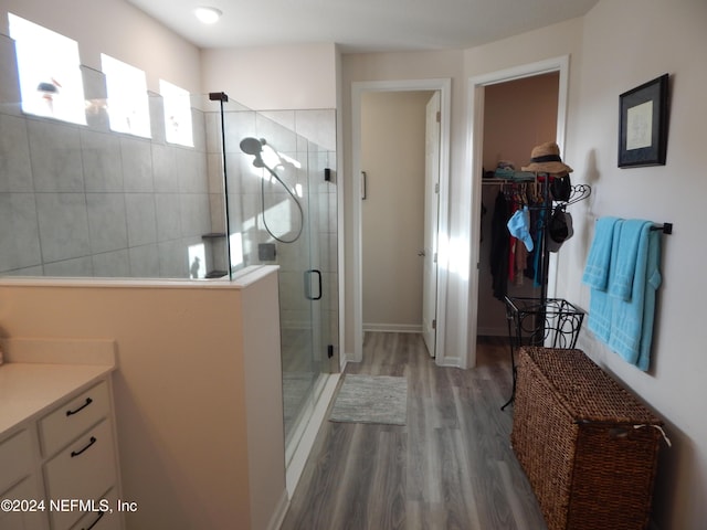 bathroom featuring vanity, hardwood / wood-style flooring, and walk in shower