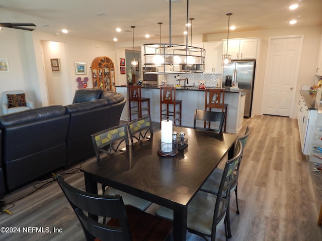 dining space with light wood-type flooring